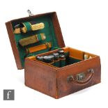 An Edwardian lady's dressing case fitted with four silver topped bottles, three brushes and other