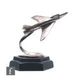 A 1950s chrome jet fighter with vapour trail, on octagonal ebonised mount, height 23cm.