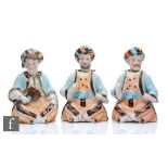 Three late 19th to early 20th Century bisque nodding figures each modelled as a seated bearded