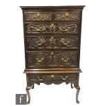 A George III and later carved oak chest on stand, fitted with two short and three long drawers