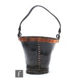A 19th Century or earlier copper studded leather fire bucket with iron ring handle, height 23cm.