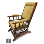 An American walnut rocking chair upholstered in pale floral design.