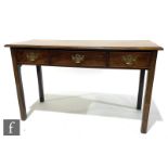A George III mahogany three drawer side table below a moulded edge top, pierced drop brass