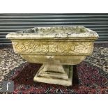 A 20th Century composite stone square planter, floral border, on stepped base, 53cm square.
