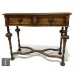 A 1920s oak two drawer side table in the William & Mary style fitted with two frieze drawers on