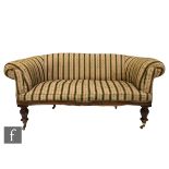 A Victorian mahogany framed two seater settee of serpentine shape upholstered in green striped