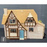 Two kit built dolls houses modelled as cottages, each with open back with four rooms, Greenleaf