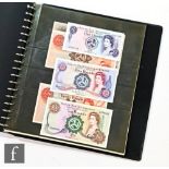 An album of Guernsey, Jersey and Isle of Man banknotes to include fifty, twenty, ten, five and one