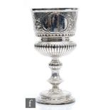 An early 20th Century hallmarked large silver goblet, circular base below knop stem, part fluted and