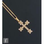 An 18ct diamond set cross detailed with twenty three brilliant cut stones, length 3cm and