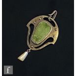 An early 20th Century pendant set with shaped oval green agate flanked by pierced sides and above