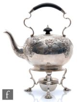 A hallmarked silver spirit kettle with conforming stand and burner, the stand raised on three pad