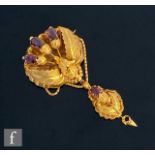 A 19th Century 18ct gold brooch with oak leaf decoration and detailed with four claw set almandine