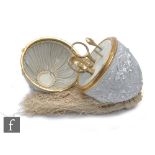 A 19th Century etui, the case formed as a hinged egg in a pressed silver metal, possibly