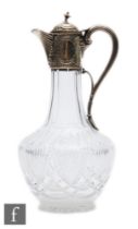 A Victorian hallmarked silver and clear claret jug, cut glass body below silver collar, hinged cover
