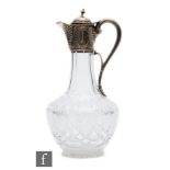 A Victorian hallmarked silver and clear claret jug, cut glass body below silver collar, hinged cover