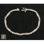 A platinum diamond set bracelet comprising ten panels of five channel set diamonds each united by