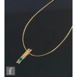 A modern 18ct hallmarked rectangular pendant set with a single emerald and two diamonds, all to an