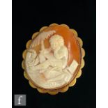 A 9ct mounted oval cameo brooch depicting a seated studying young boy, weight 29g, length 6.5cm,