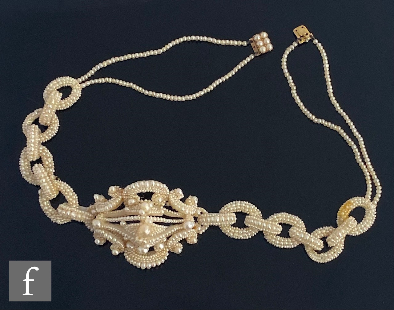 A cased 19th Century seed and mother of pearl choker comprising a central pierced cluster flanked by