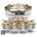 A hallmarked silver punch bowl of plain form with stepped circular base and terminating in floral