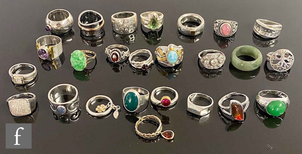 Twenty four assorted silver, white metal and other rings to include stone set and other examples. (