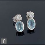 A pair of 18ct white gold aquamarine and diamond stud earrings, brilliant cut diamond, weight