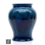 A large early 20th Century Moorcroft vase of inverted baluster form decorated in the Moonlit Blue
