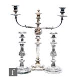 A pair of 19th Century silver plated candlesticks, circular bases with foliate decoration below knop