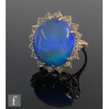 A 9ct hallmarked opal doublet and diamond cluster ring, central opal, length 18mm, within a
