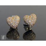 A pair of 18ct diamond encrusted, heart shaped, stud earrings, total weight 4.4g, signed Cartier and