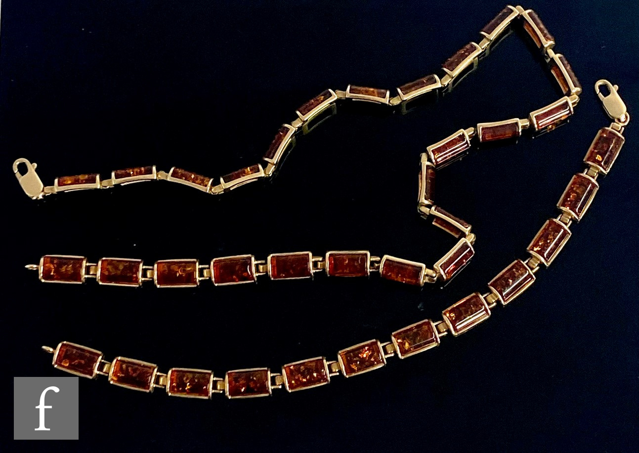 A 9ct mounted Baltic amber necklet comprising twenty five rectangular panels, length 40cm, with a