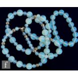 A single row necklet of moonstone style beads of various sizes and spaced with white metal shot