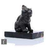 A bronze study of a seated cat to a variegated black marble base, length 12cm.