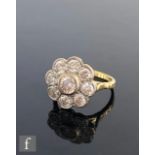 An 18ct diamond daisy cluster ring, central collar set stone, weight approximately 0.50ct, within