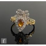 A 9ct hallmarked citrine and diamond cluster ring, pear shaped citrine within a diamond surround
