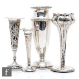 Three hallmarked silver trumpet vases, one modelled as a tulip, with a white metal Asian example.
