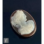 A 9ct mounted oval hard stone cameo brooch, head and shoulder profile of a classical maiden,