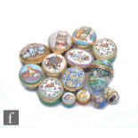 Fourteen cat themed Halcyon Days enamel pill boxes each decorated with scenes of cats to include two
