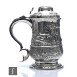 A Georgian hallmarked silver tankard and hinged cover, later embossed with a landscape setting