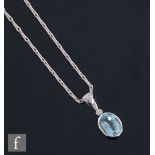 An 18ct white gold aquamarine and diamond set pendant suspended from a 9ct white gold hayseed link
