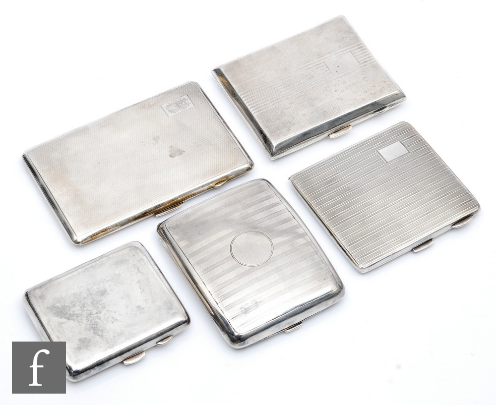 Five early 20th Century hallmarked silver cigarette cases, four with engine turned decoration and