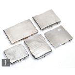 Five early 20th Century hallmarked silver cigarette cases, four with engine turned decoration and