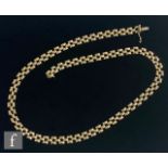 A modern 9ct necklet of open brick link form, weight 16.5g, length 43cm, terminating in tongue and
