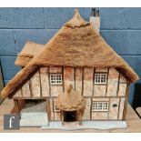 A Little Homes of England 1:12 scale dolls house modelled as a thatched cottage by Graham Wood,