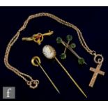 A small parcel lot of 9ct jewellery to include a cross and chain, two brooches and two stick pins,