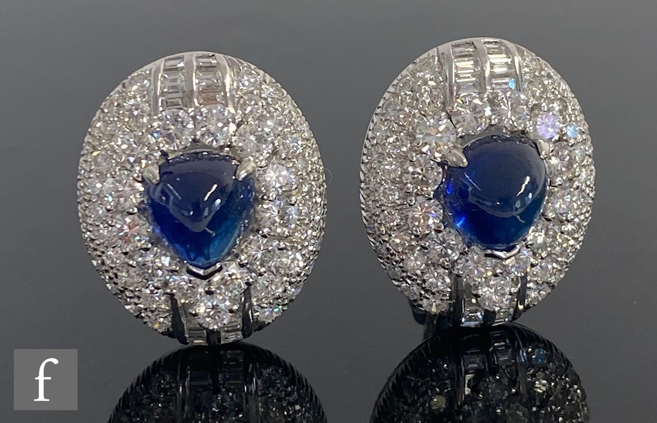 A pair of sapphire and diamond 18ct white gold oval cluster stud earrings, central cabochon sapphire