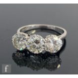 An platinum set diamond three stone ring, brilliant cut claw set stones, total weight