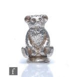 An Edwardian hallmarked silver pepper pot modelled as a seated Teddy bear, height 4cm, Birmingham