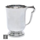 A hallmarked silver tankard of circular stepped base below plain flaring body, weight 10.5oz, height